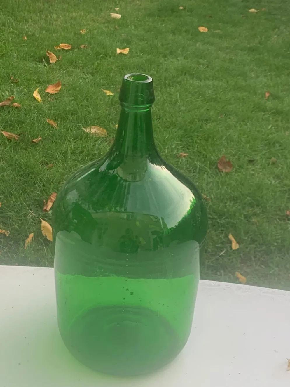 Dame jeanne en verre verte vintage