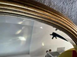Grand miroir Ovale Deknudt en bois doré années 70