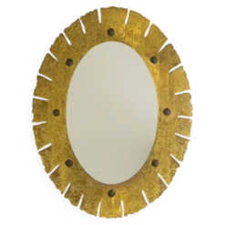 Miroir de forme elliptique en laiton martelé et doré. Années 1950-60.