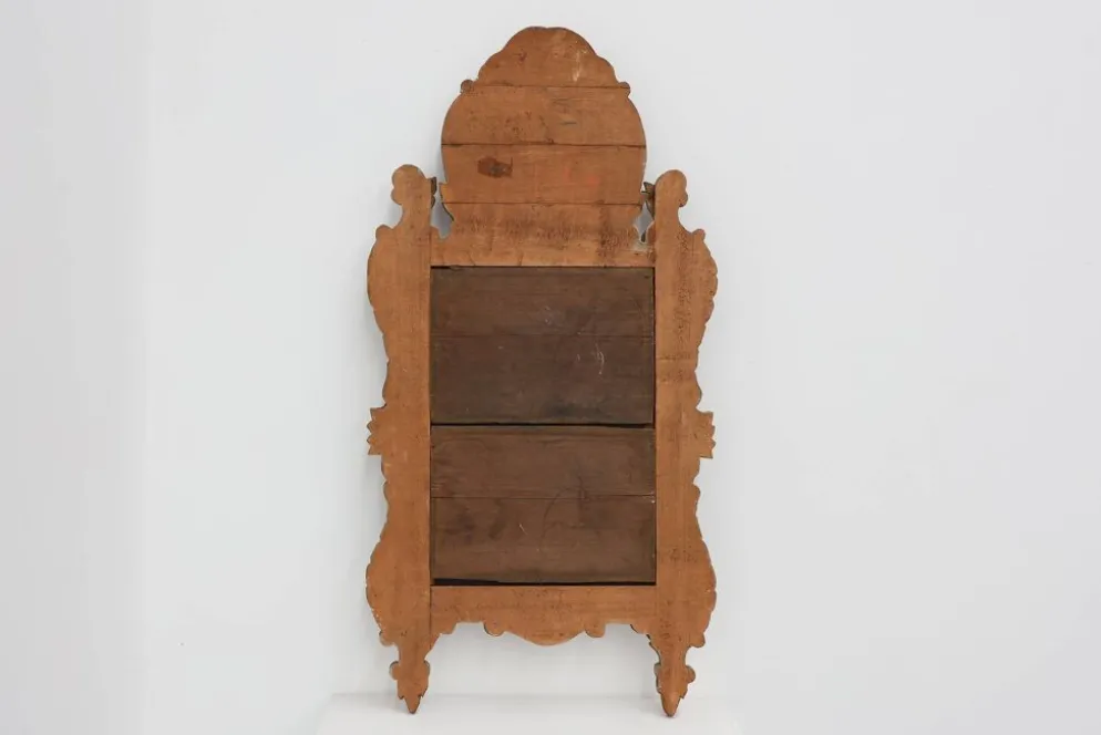 Miroir en bois doré sculpté de style Louis XV avec un fronton floral, France, 18ème siècle.