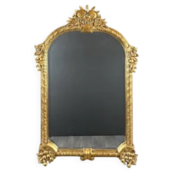 Miroir en bois sculpté et doré à décor de fruits et de fleurs, XXe siècle