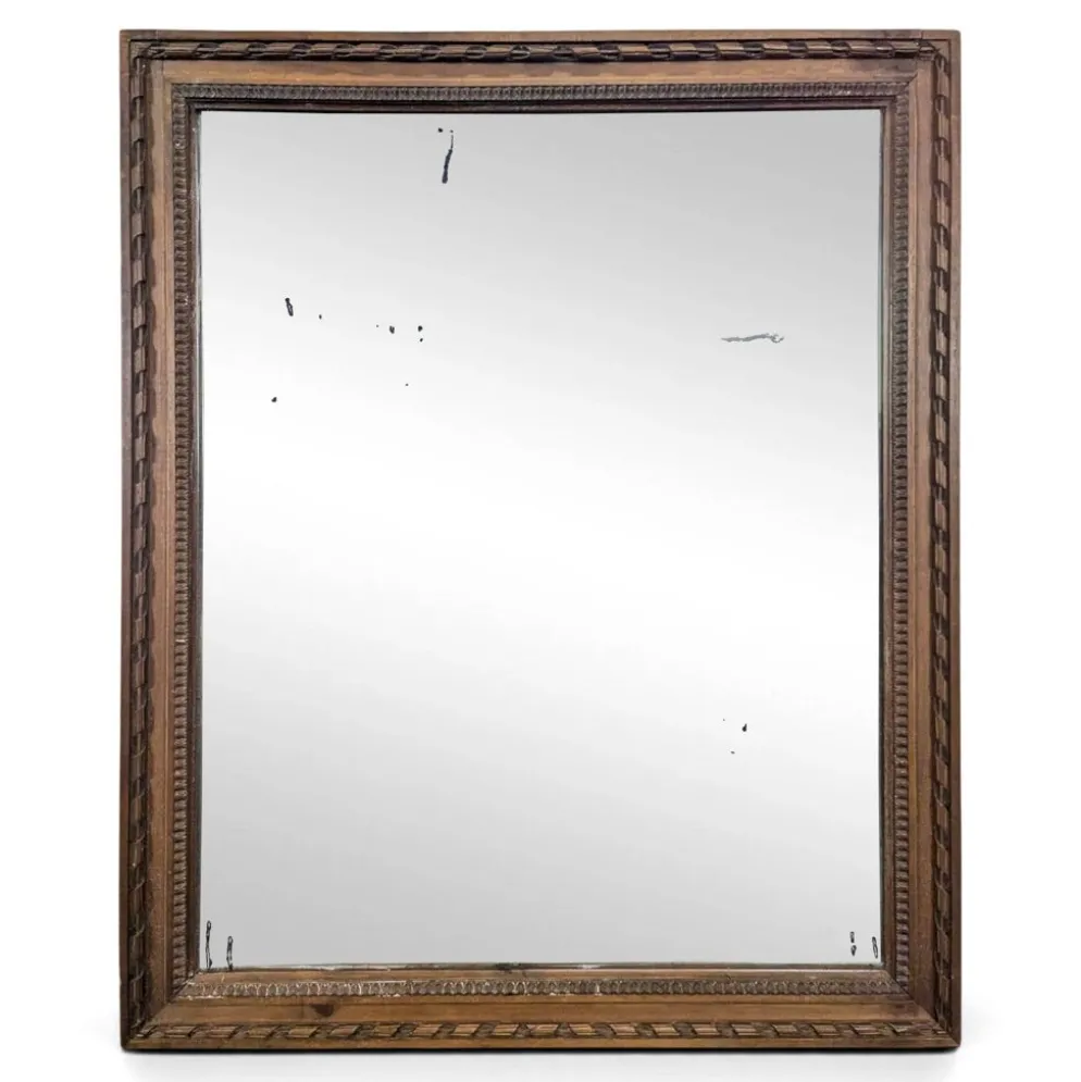 Miroir Napoléon III à cadre en bois sculpté et doré