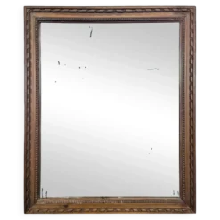Miroir Napoléon III à cadre en bois sculpté et doré