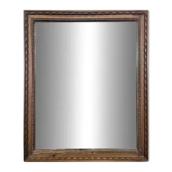 Miroir Napoléon III à cadre en bois sculpté et doré