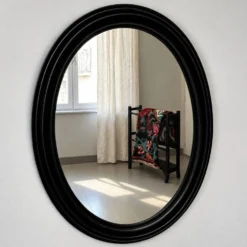Miroir ovale ancien en bois patiné noir
