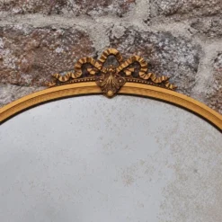 Miroir ovale vintage en métal doré à nœud – style Louis XVI / romantique