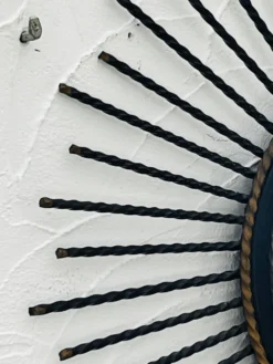 Miroir soleil vintage en métal noir et doré années 60