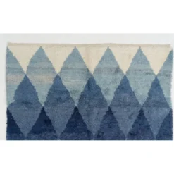 Tapis en laine contemporain avec des diamants bleus entrelacés.
