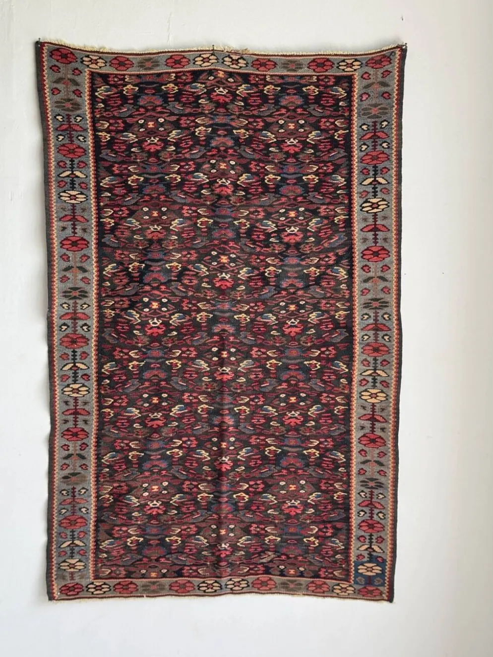 Tapis iranien à motifs floraux stylisés roses et bleus 155x105
