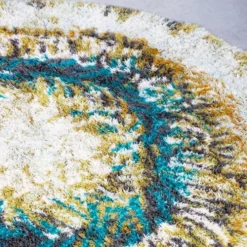 Tapis Rya en laine beige, marron et turquoise.